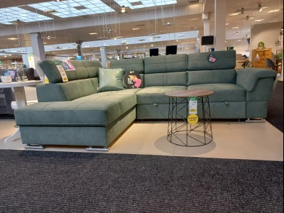 Современный угловой диван зелёного цвета с раскладным механизмом.