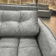 Серый диван с глубокой посадкой и объемной стеганой поверхностью