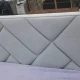 Двоспальне ліжко з м'якою спинкою та геометричню прошивкою