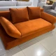 Компактна софа помаранчевого кольору з розкладним механізмом