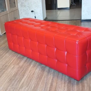 Довгий м'який пуф з каретною стяжкою на сидінні та фасаді