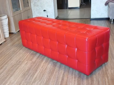 Довгий м'який пуф з каретною стяжкою на сидінні та фасаді